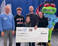 Stinger and Ohio 529 Executive Director Tim Gorrell stand with the winners of the CBJ College Savings Assist, the Sabo Family