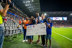 Jordanne Wells and her family accepts her check from Trisha Good, Executive Director of Ohio's 529 Plan, on field at the Sept. 23 game