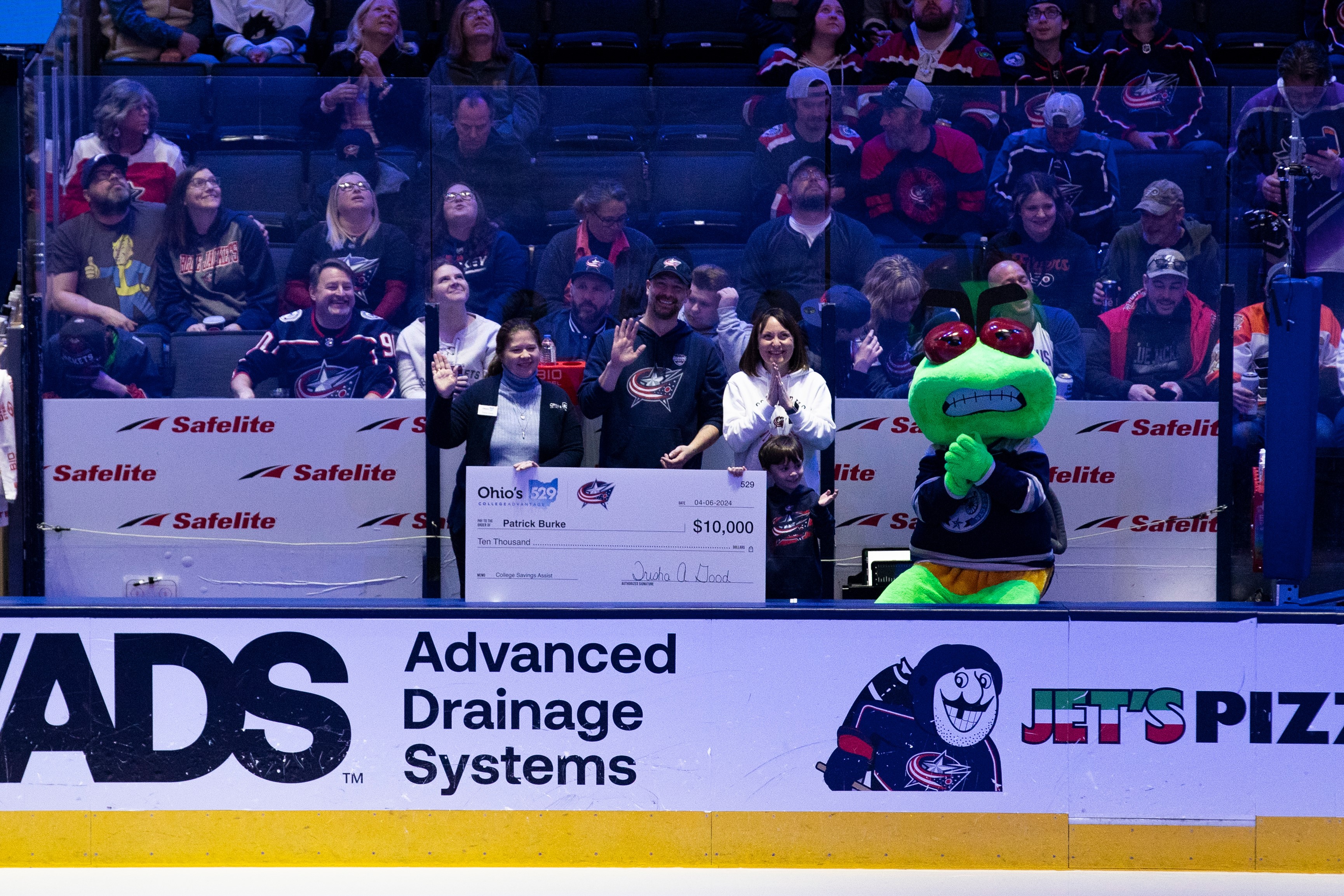 Trisha Good, Patrick Burke and his family and Stinger waves to the crowd at the 2024 CBJ College Savings Award check presentation