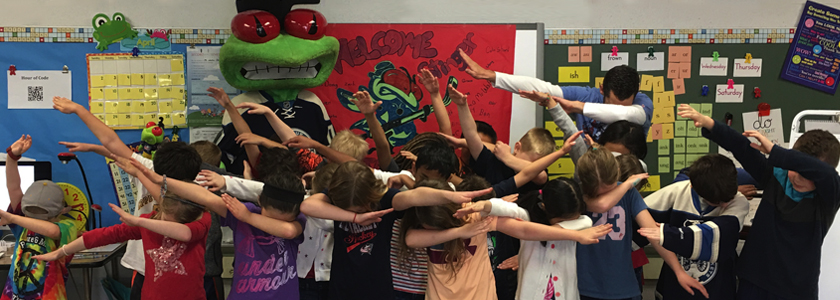 Stinger and students dance as part of their Book Jacket pizza party