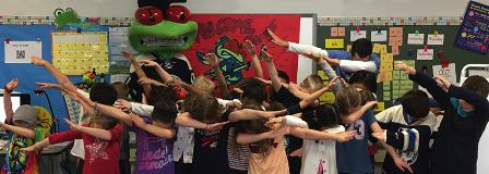 Stinger and students dance as part of their Book Jacket pizza party