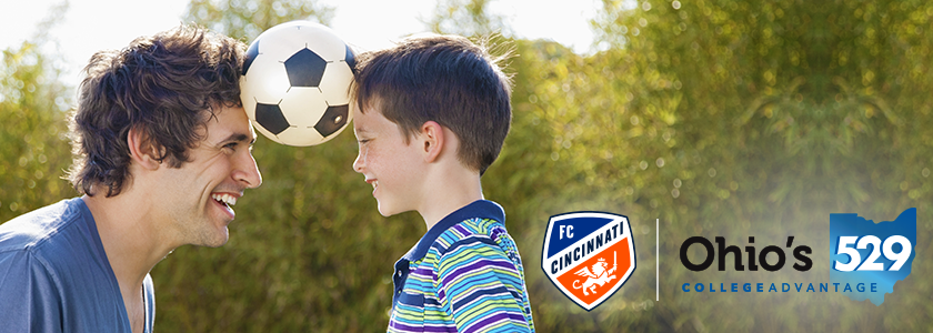 FC Cincinnati College Savings Goal Father and young son balance soccer ball between their heads