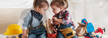 Two little girls surrounded by tools