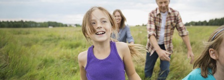 Family walking through open field