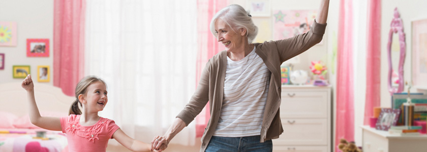 Grandmother and granddaughter dancing together