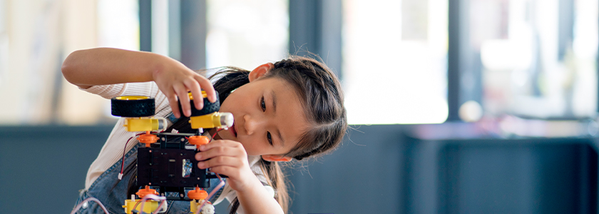 Girl building a robot