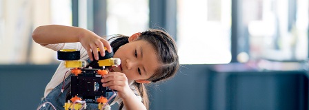 Girl building a robot