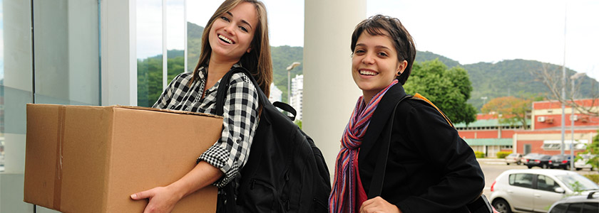 Mother and daughter setting up her college dorm room