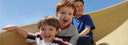 three children coming down a slide