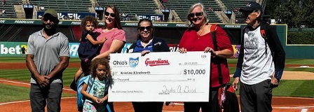 2023 Cleveland Guardian Home Run winner Kristine Klindworth accepts the check from Ohio 529 Executive Director Trisha Good . Kristine was joined by her husband John, and daughter Ann, son-in-law Isaiah, and grandchildren Zena and Kaeva.