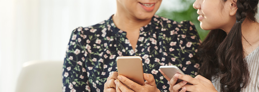 Mom and teenaged daughter talk over their cell phones