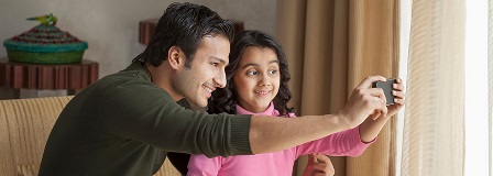 Father and daughter take a selfie together