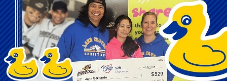 Father, daughter, and mother hold oversized check. Rubber Ducks surround them in the frame.