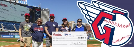 2025 Cleveland Guardian winner Maura Johnson, with her family, holds her oversized check from Trisha Good, Ohio 529 executive director