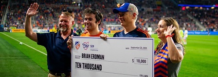 Family holds oversized check from Ohio 529 and FC Cincinnati on field at TQL Stadium