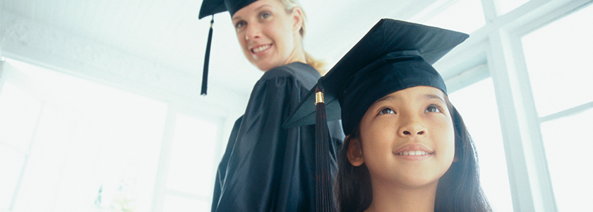 Give A Graduate The Gift Of Higher Education High school graduate and 5th grade graduate dressed in caps and gowns