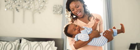 Mother swinging her baby in her arms