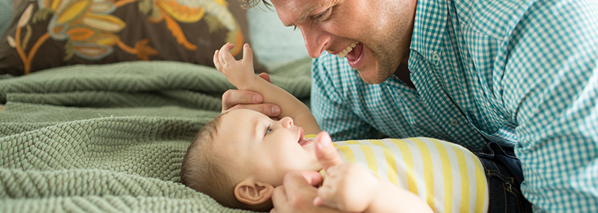 Dad smiling at his happy baby