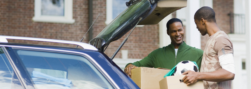 GENERAL_069 Father and son unpacking car as son heads off to college