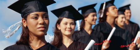 A line of recent graduated hold their diplomas