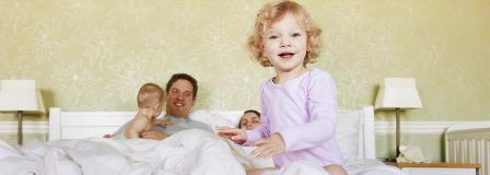 parents-with-toddler-and-baby-in-bedroom