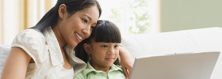 Mother and daughter looking at laptop together
