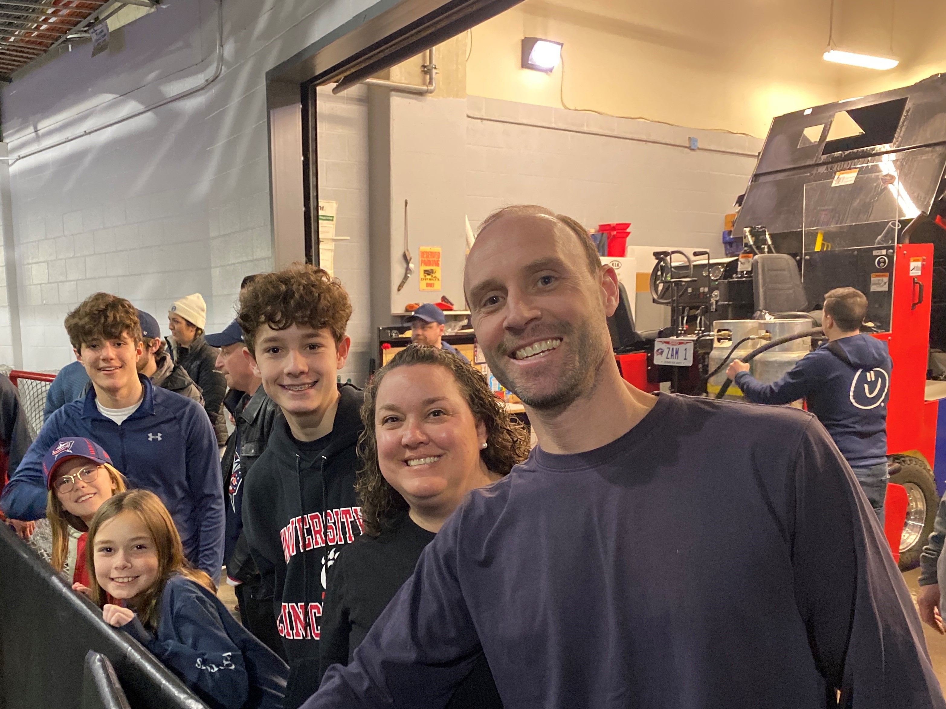 The 2023 CBJ College Savings Assist winners, the Sabo Family, stand in the Tunnel of Pride