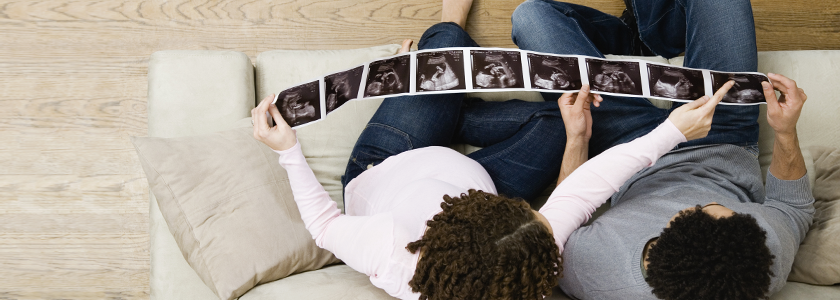 A young couple looks at sonograms