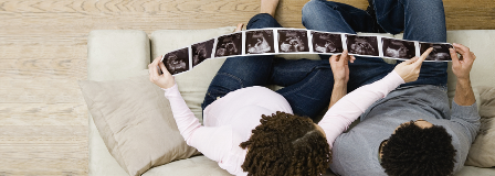 A young couple looks at sonograms