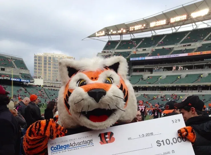 Bengals mascot holding check